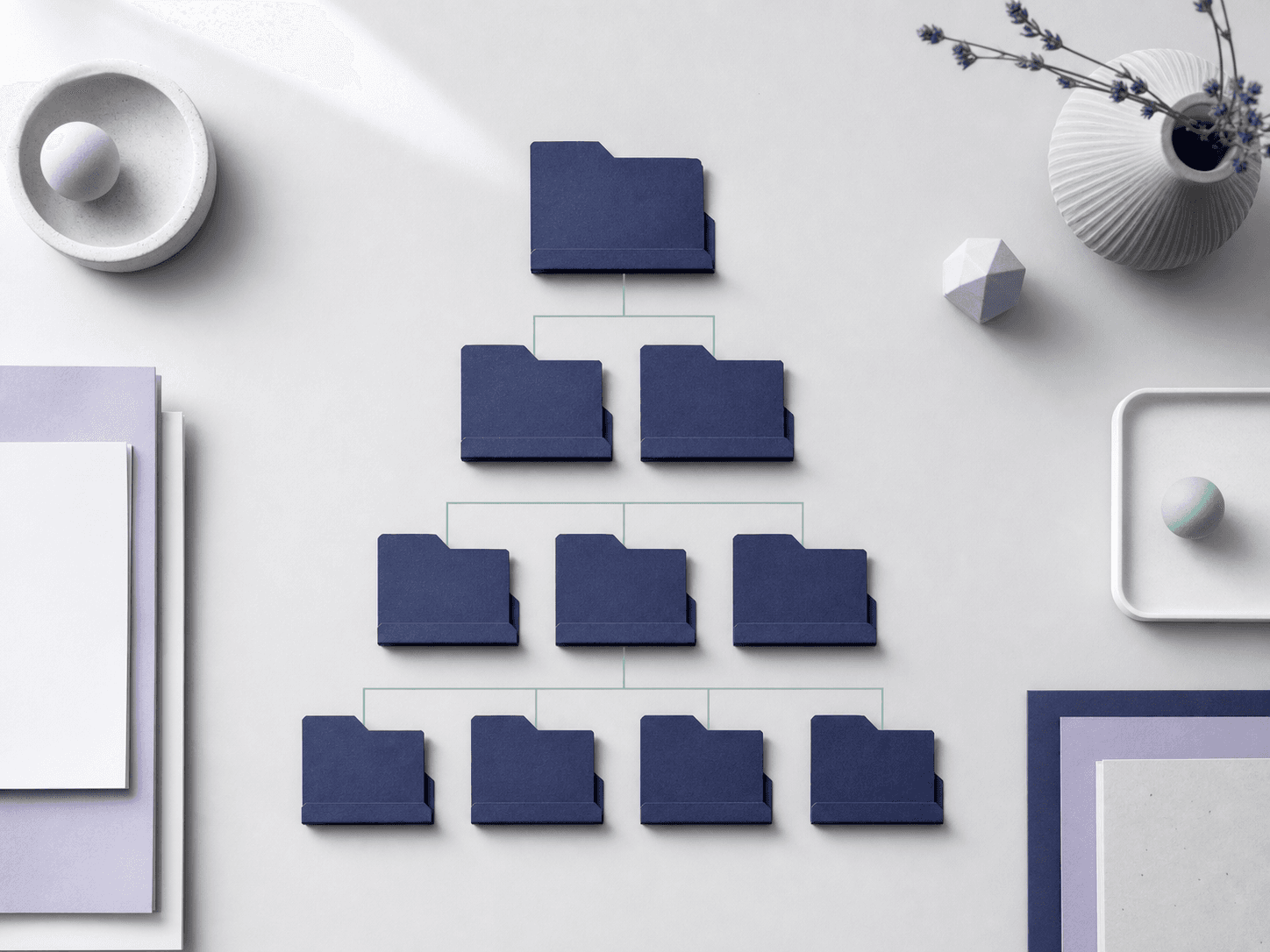 Abstract vertical hierarchy of indigo folded-paper tabs stepping down in three indented tiers