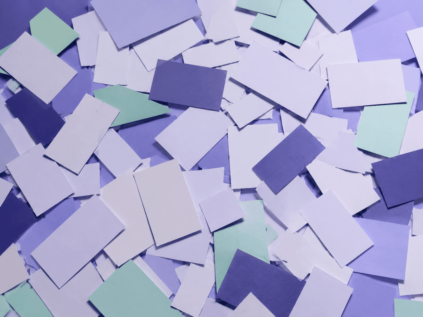Many small pale rectangles scattered at random angles and overlapping chaotically across a violet plane